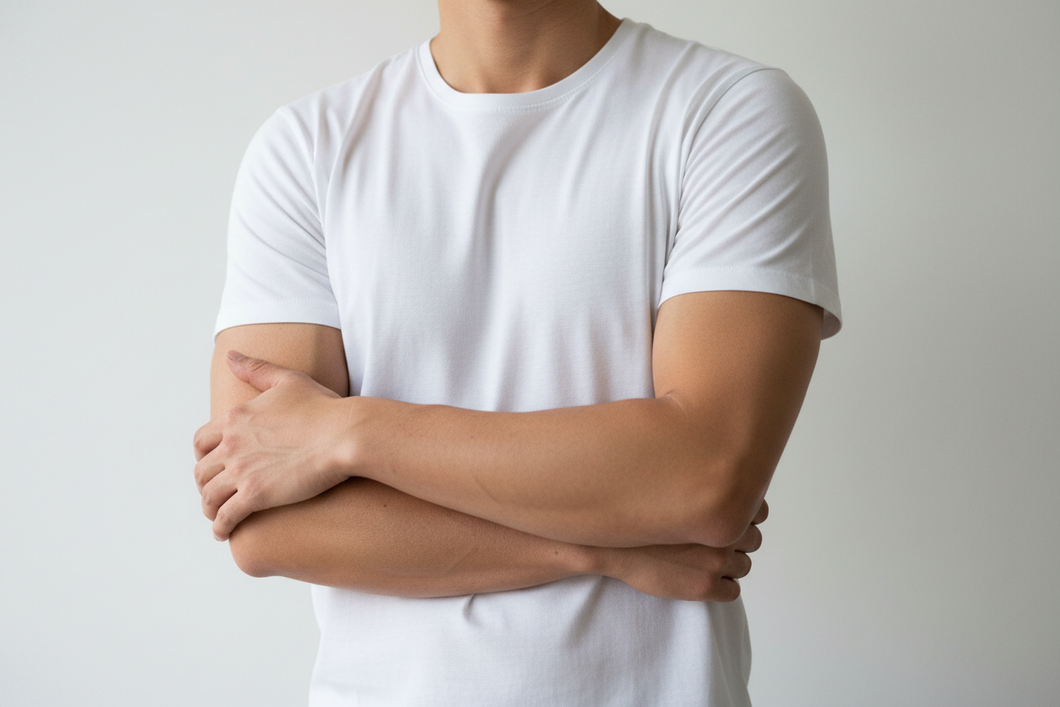 from the neck down show a man in a white t shirt arms crossed
